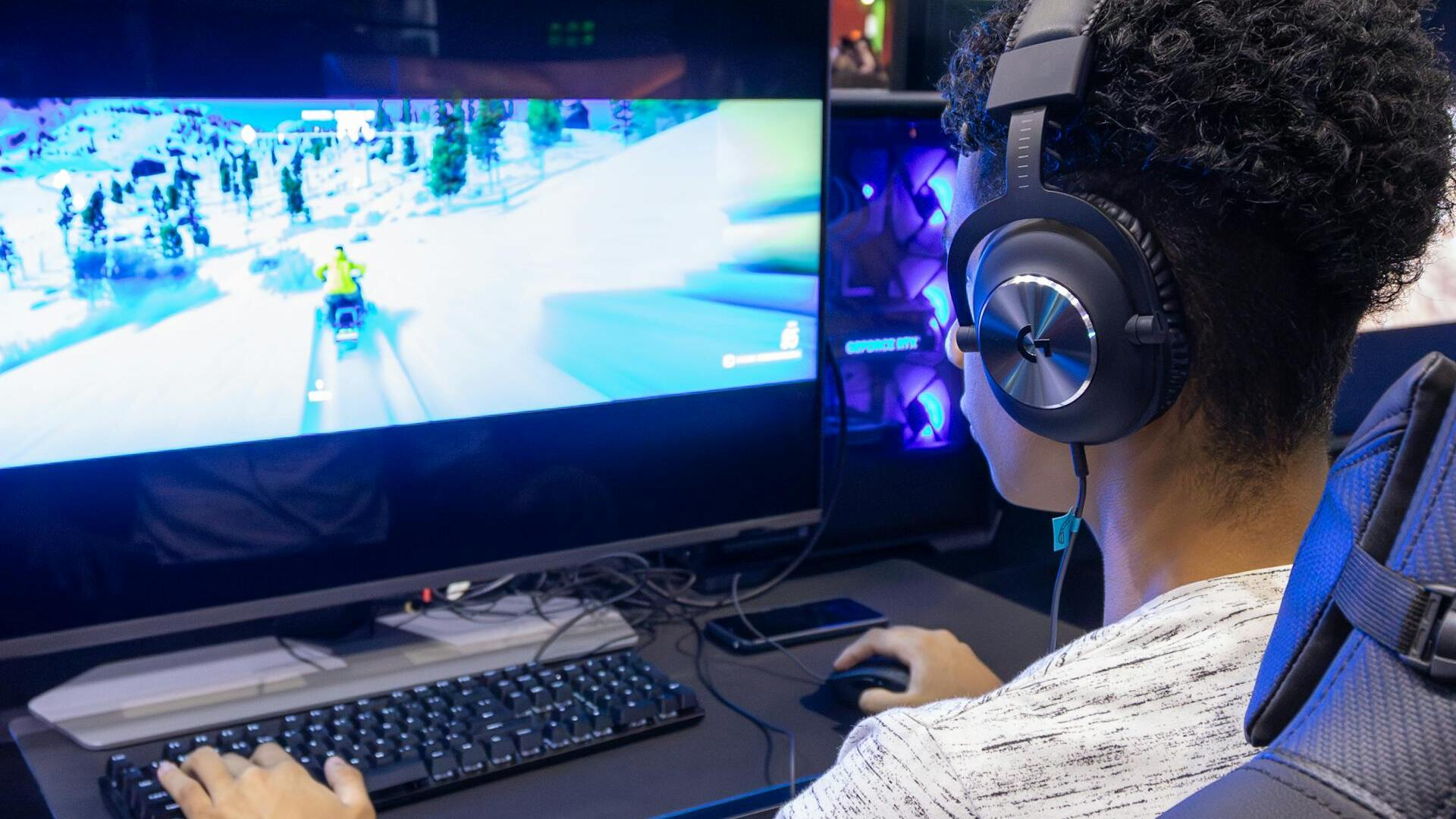 Man looking at computer screen playing game