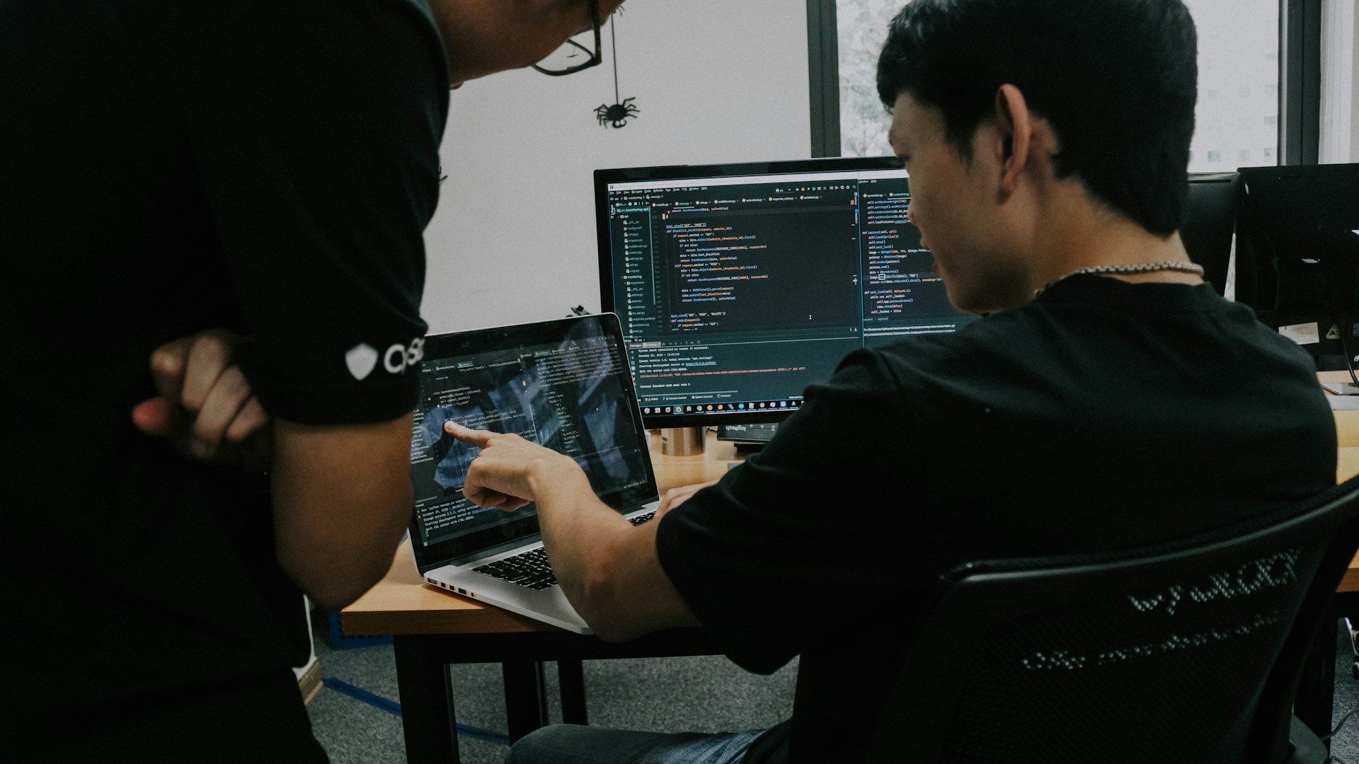 Two men working on computers in an office